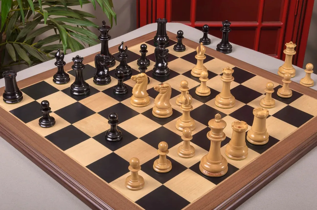 House of Staunton's 1849 Cooke luxury chess set, ebony and boxwood pieces mid-game on a wooden board